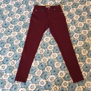 Maroon skinny jeans with black accents